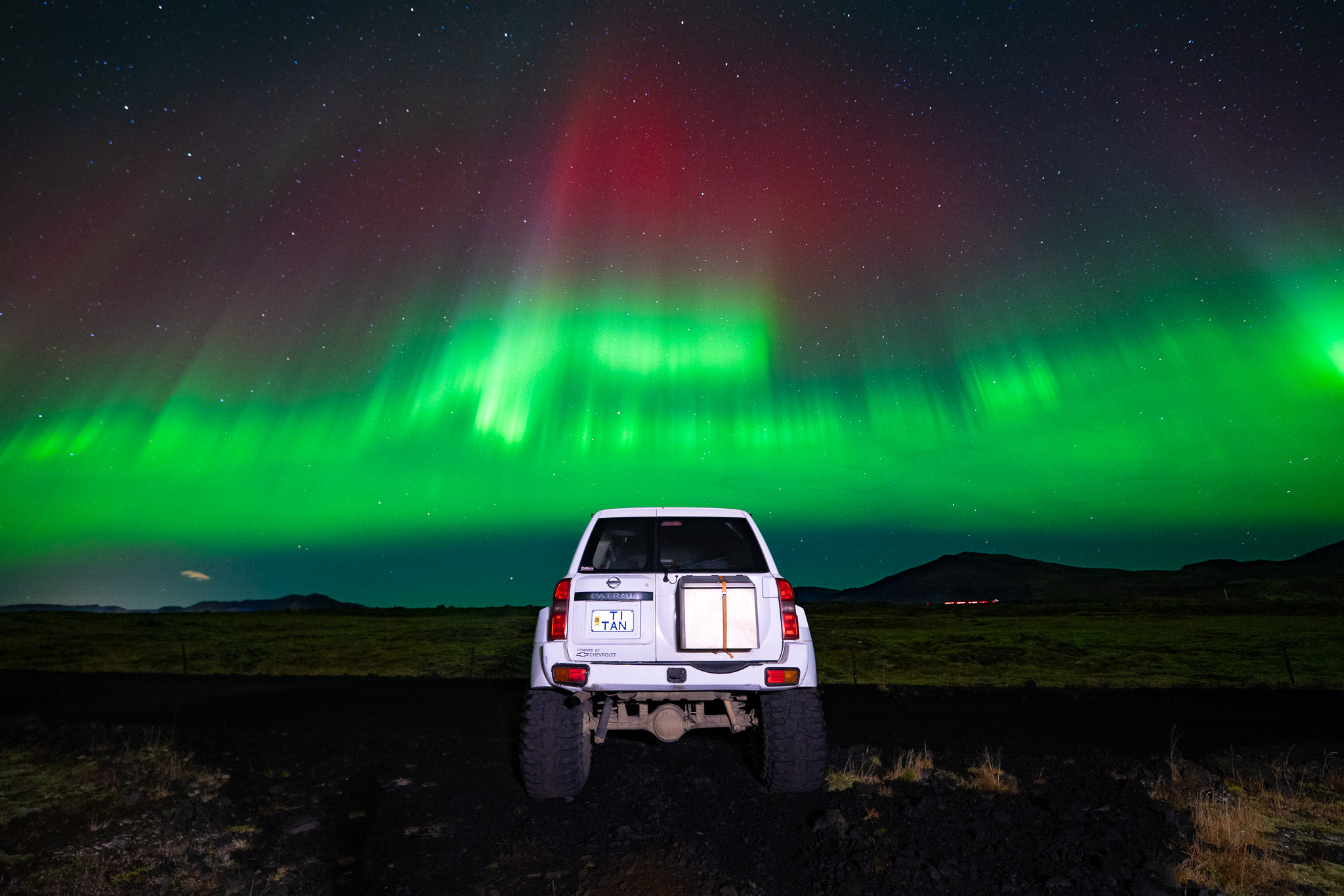 A Nissan Patrol Superjeep beneath the Northern Lights